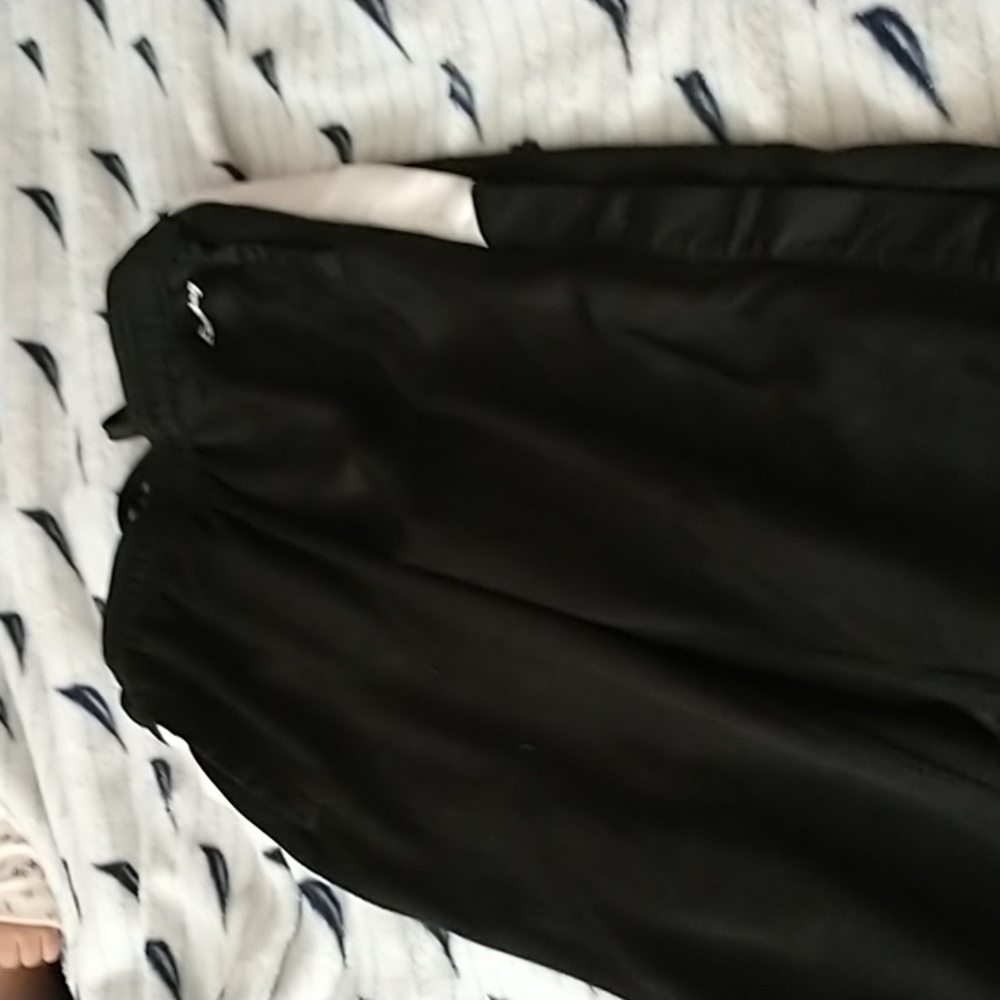 Black sweatpants that button all the pay down the side